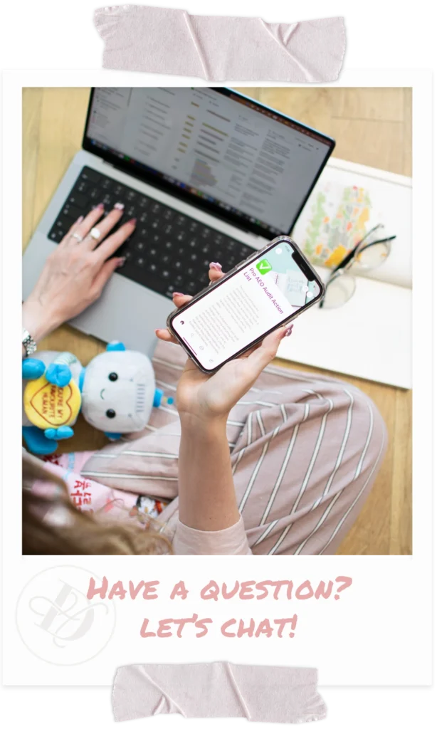 top down view of woman typing on laptop and holding phone in her hand