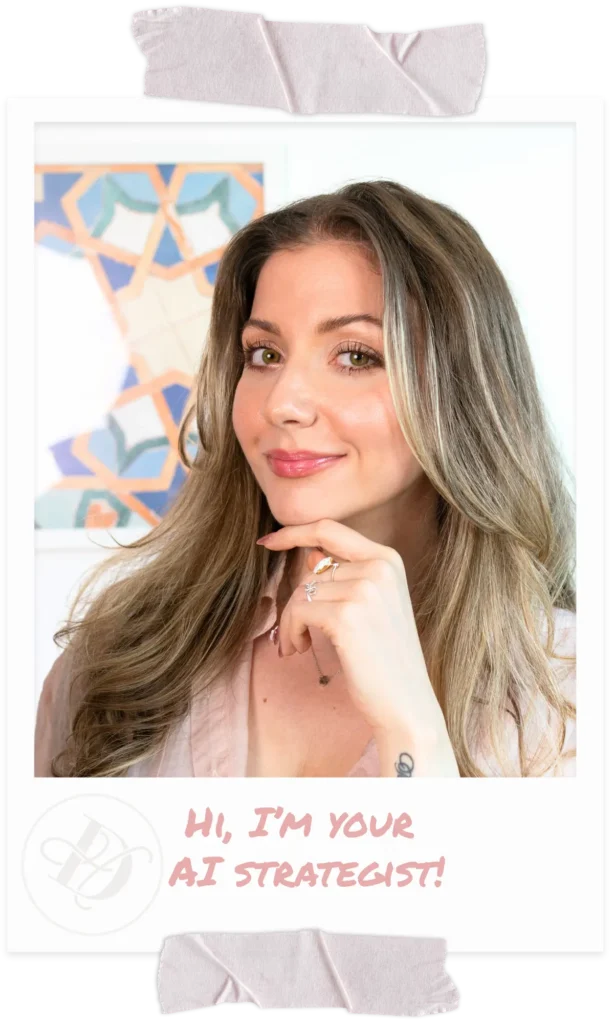 Woman with long light brown hair smiling, resting her chin on her hand, wearing a pink blouse