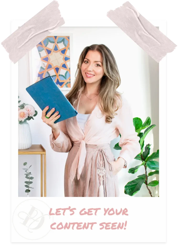 Woman smiling while holding a blue tablet, dressed in a light pink blouse and striped trousers